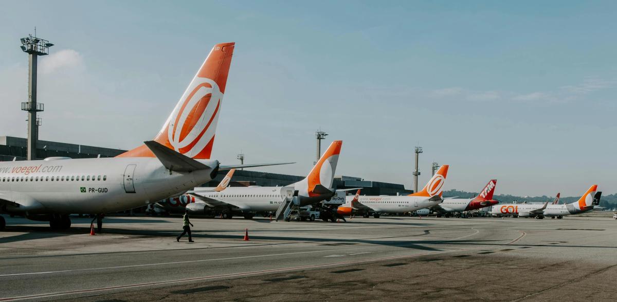 Multiple GOL Airlines Boeing 737 aircraft lined up at an airport gate, emphasizing the airline's standardized fleet strategy.