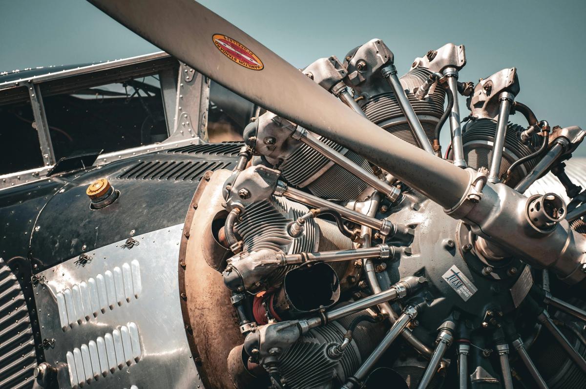 Image of a vintage aircraft’s engine and propeller. It highlights the challenges to maintaining a diverse fleet with aircraft parts of varying ages and service lifespans.