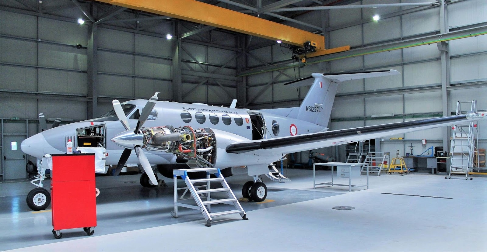 Inside an aviation maintenance facility featuring a repair hangar and organized storage for thousands of aviation parts.