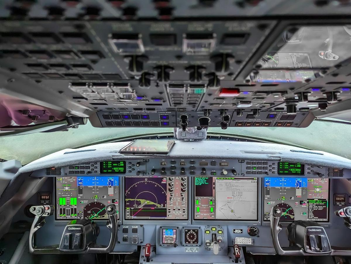 Close-up view of an aircraft cockpit with digital displays, switches, and flight controls, illustrating the complexity of aviation procurement; AI-powered email tools can automate and streamline purchasing processes for aviation MRO and procurement teams.