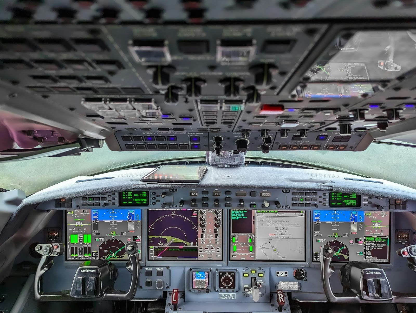 Close-up view of an aircraft cockpit with digital displays, switches, and flight controls, illustrating the complexity of aviation procurement; AI-powered email tools can automate and streamline purchasing processes for aviation MRO and procurement teams.