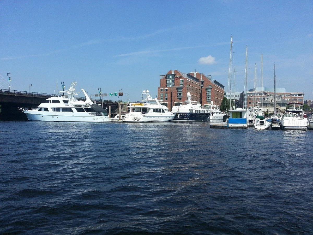 Motor yachts and sailboats moored along the Charlestown waterfront