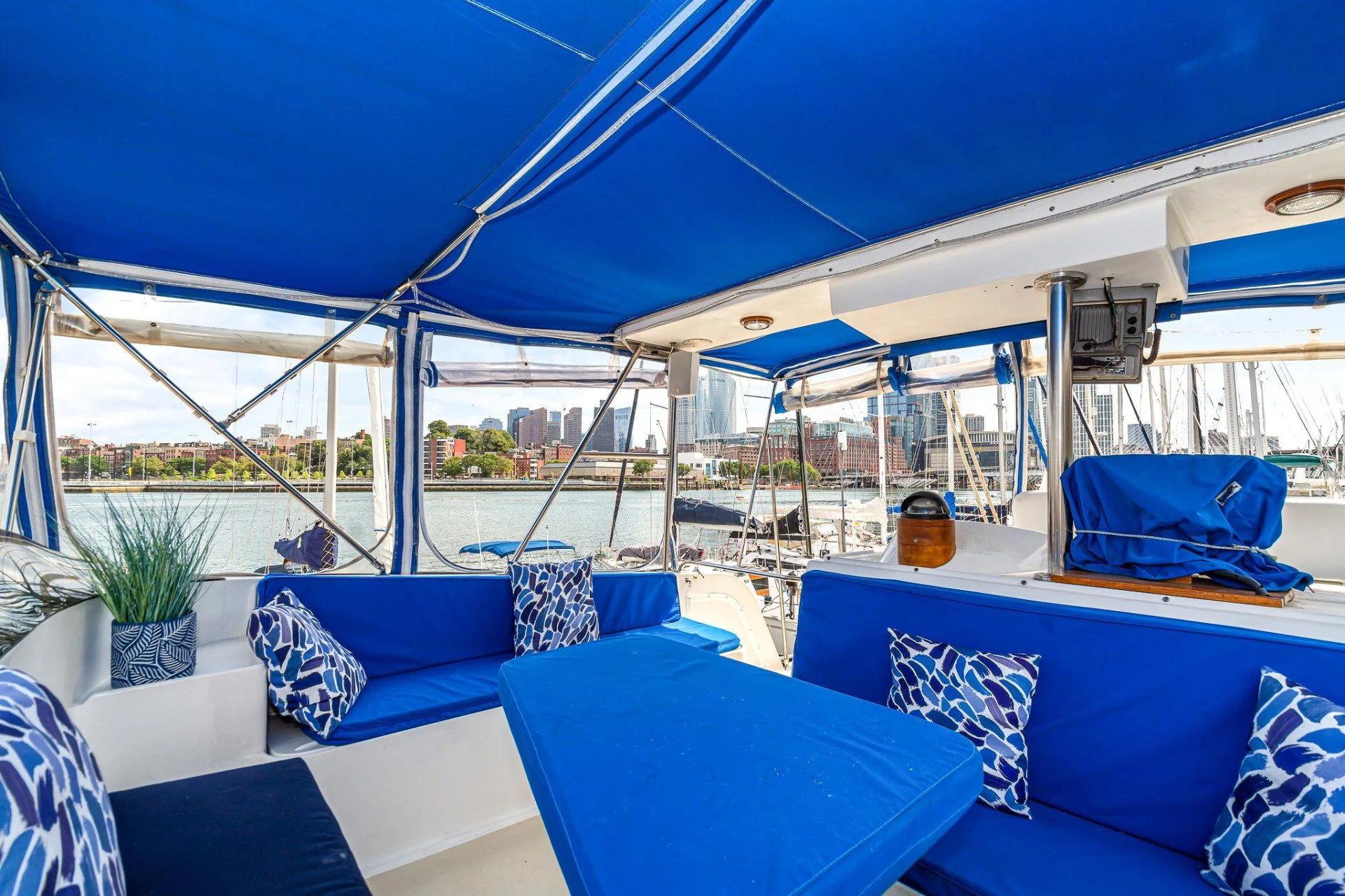 The private deck aboard Blue Waters with seating and harbor views