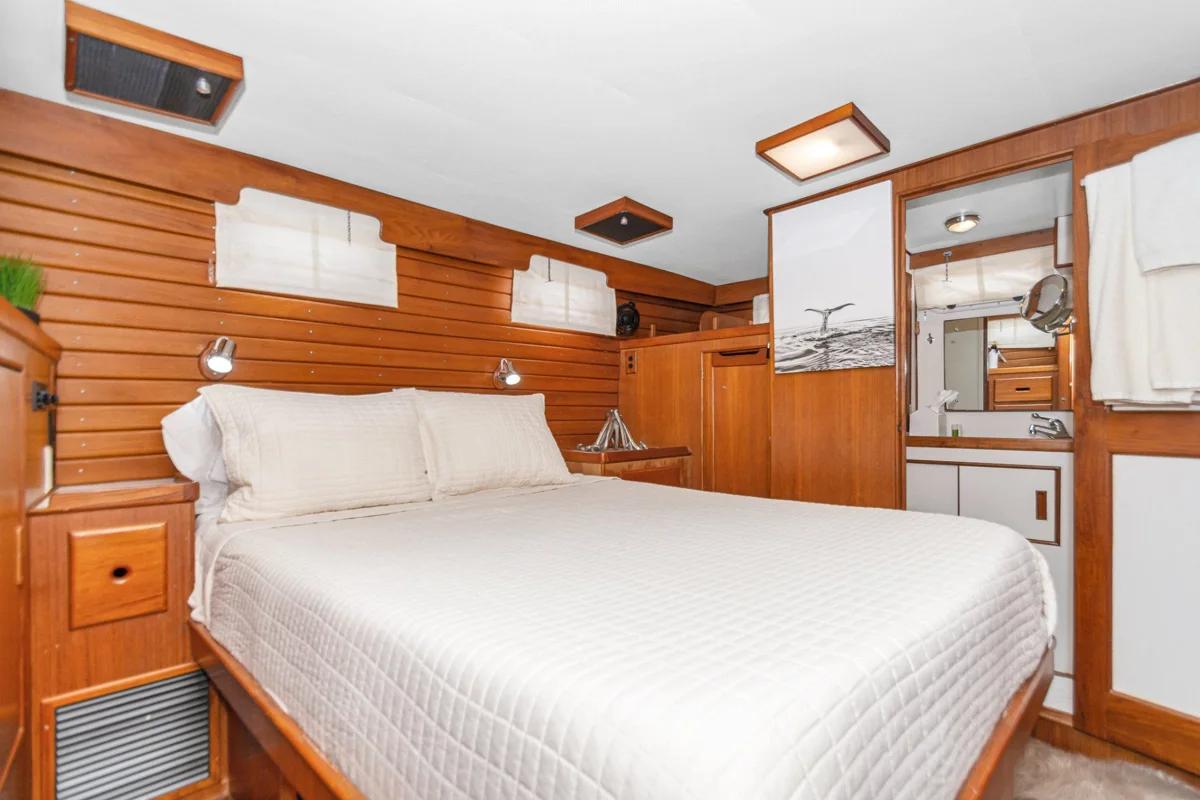 Wood paneled aft stateroom aboard Blue Waters