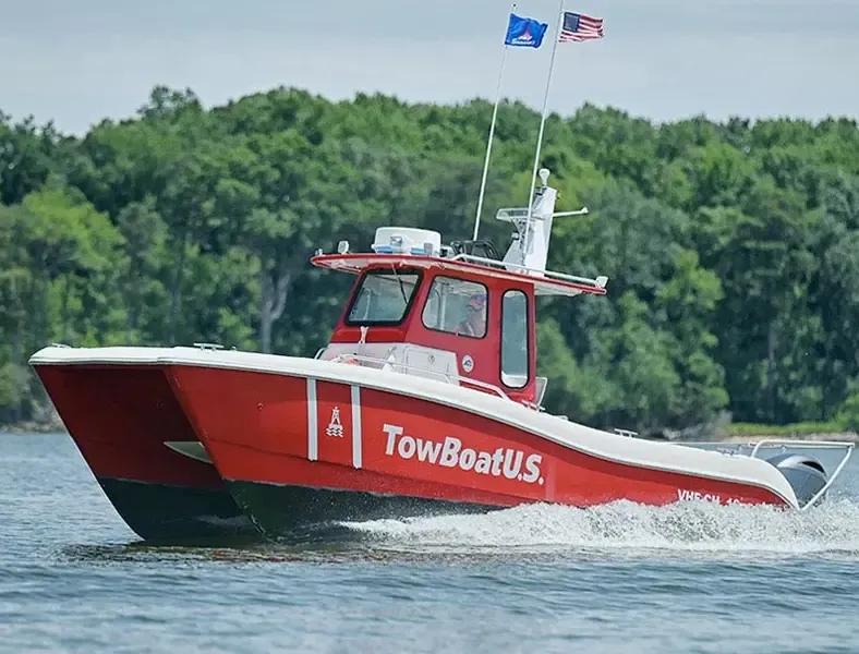 A red TowBoatUS assistance boat on the water
