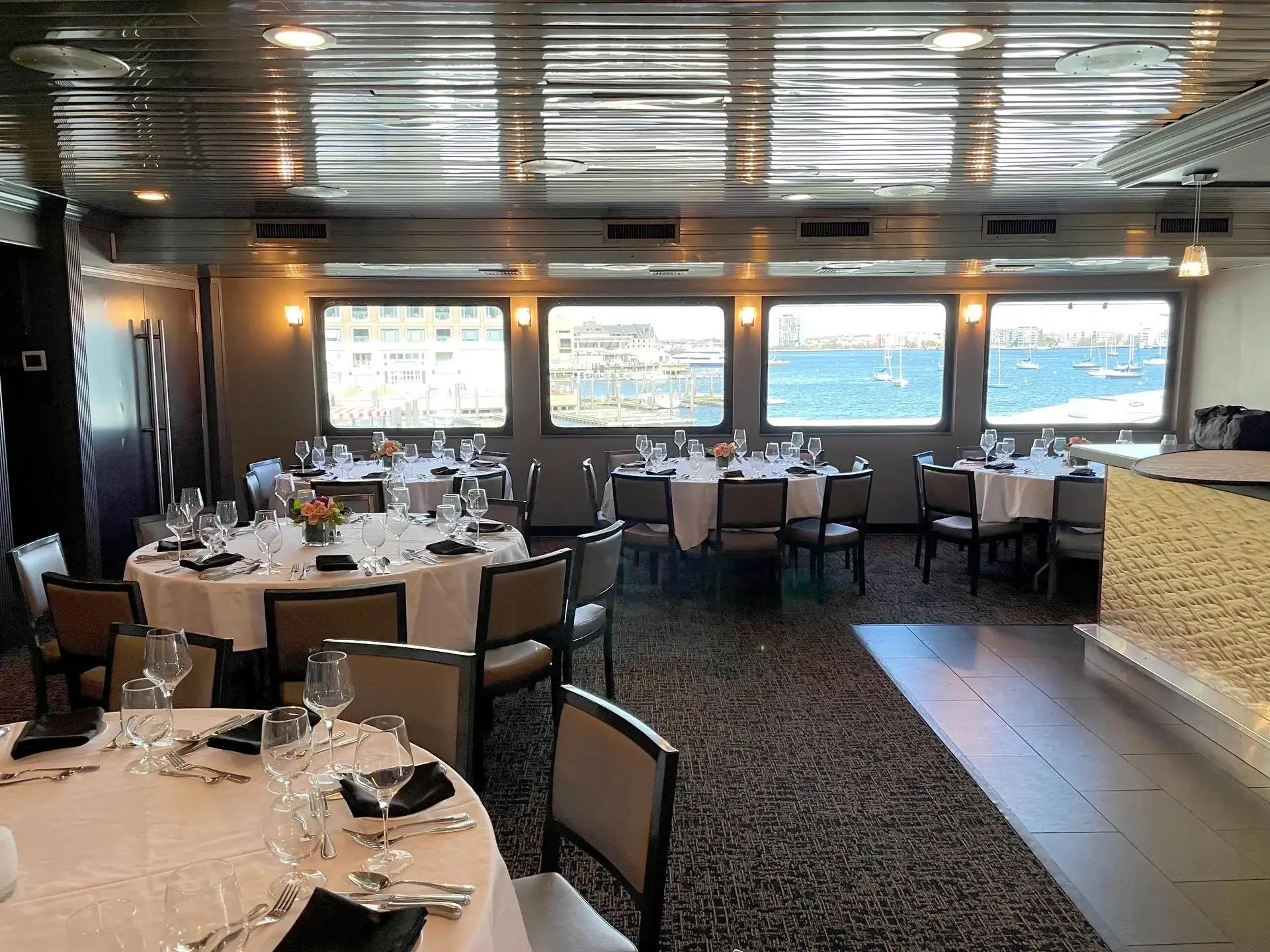Tables set for an event inside a charter vessel