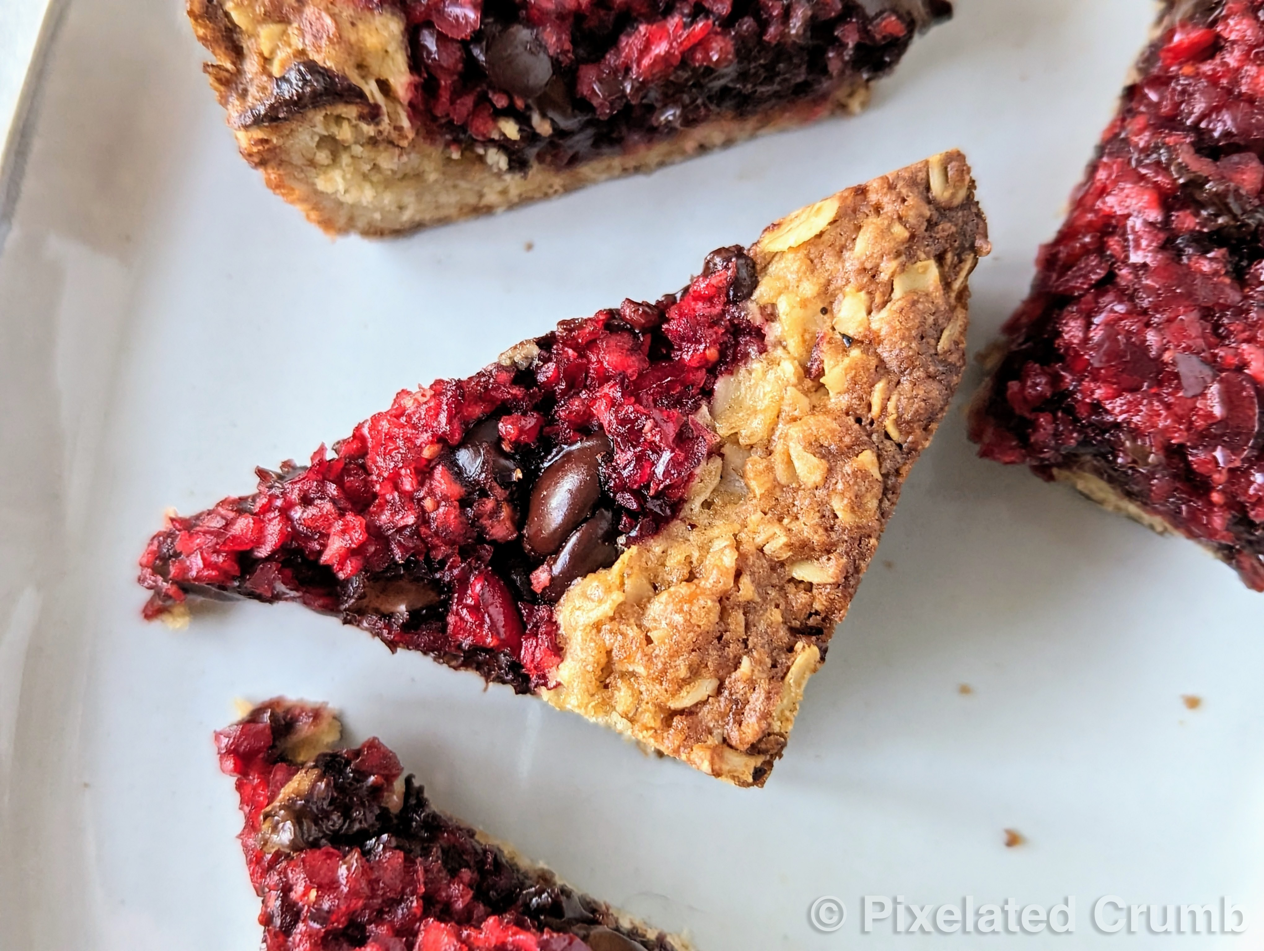 chocolate cranberry bars on a plate