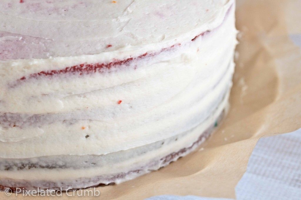 Crumb Frosting Layer on Rainbow Cake