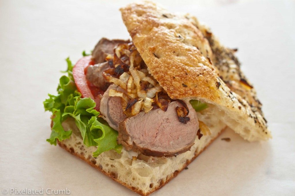 Bifana - Portuguese Sliced Pork Tenderloin Sandwich with Caramelized Onions and Garlic Aioli on Focaccia Bread
