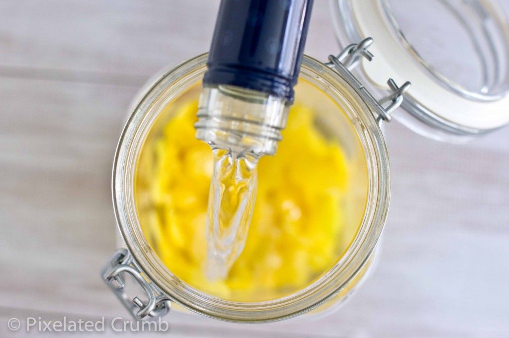 Pouring Vodka Over Lemon Peels