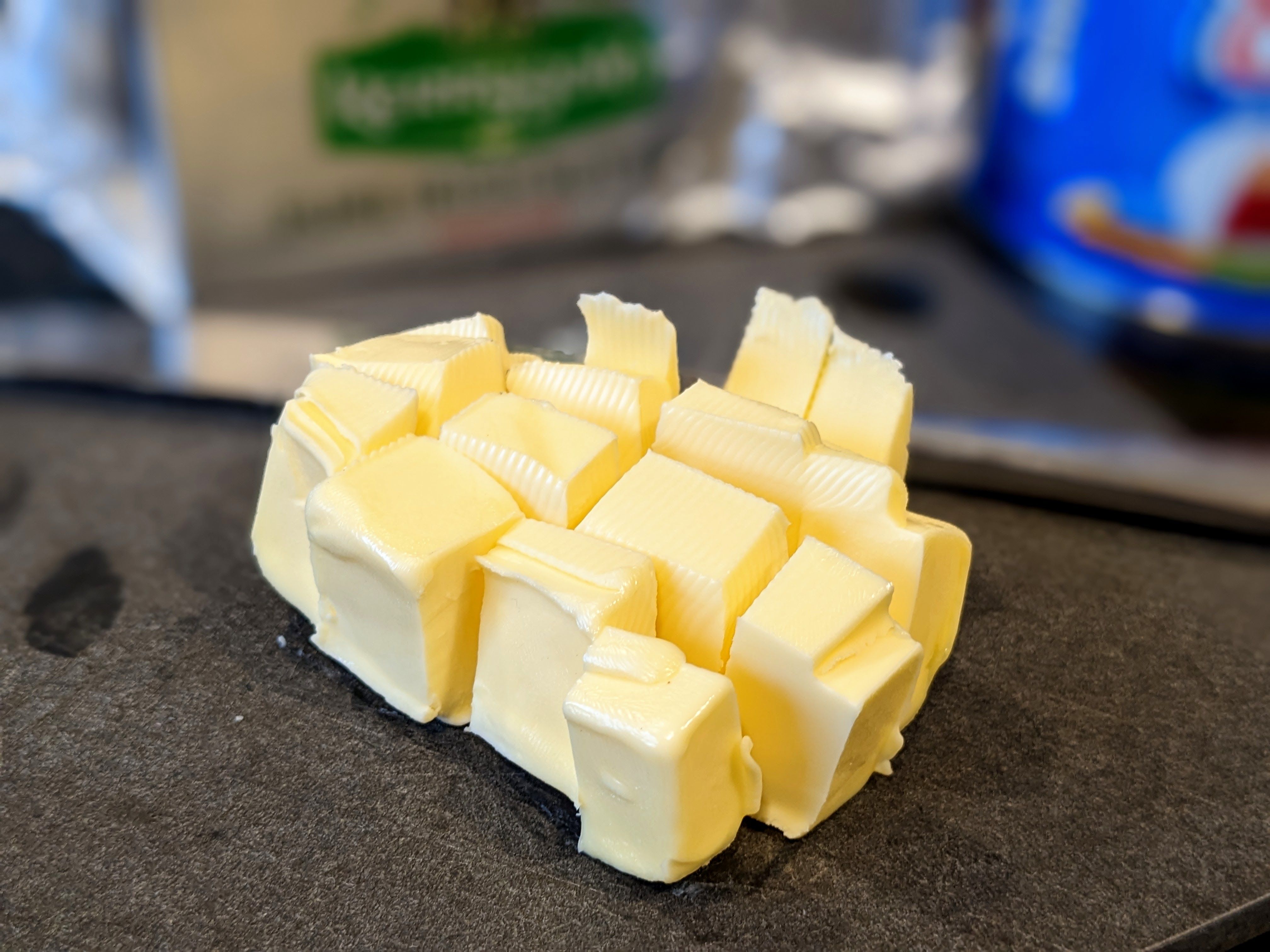 Cut up butter with Kerrigold wrapper in background