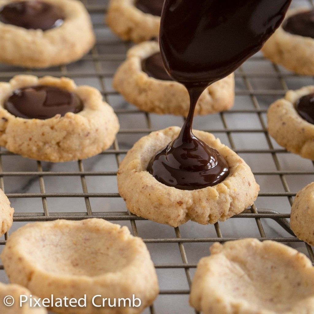 Drizzling chocolate in Chocolate Almond Thumbprints with Fleur de Sel