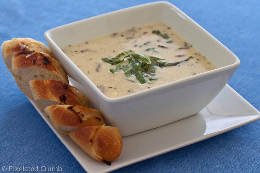 Bowl of corn chowder with sliced bread