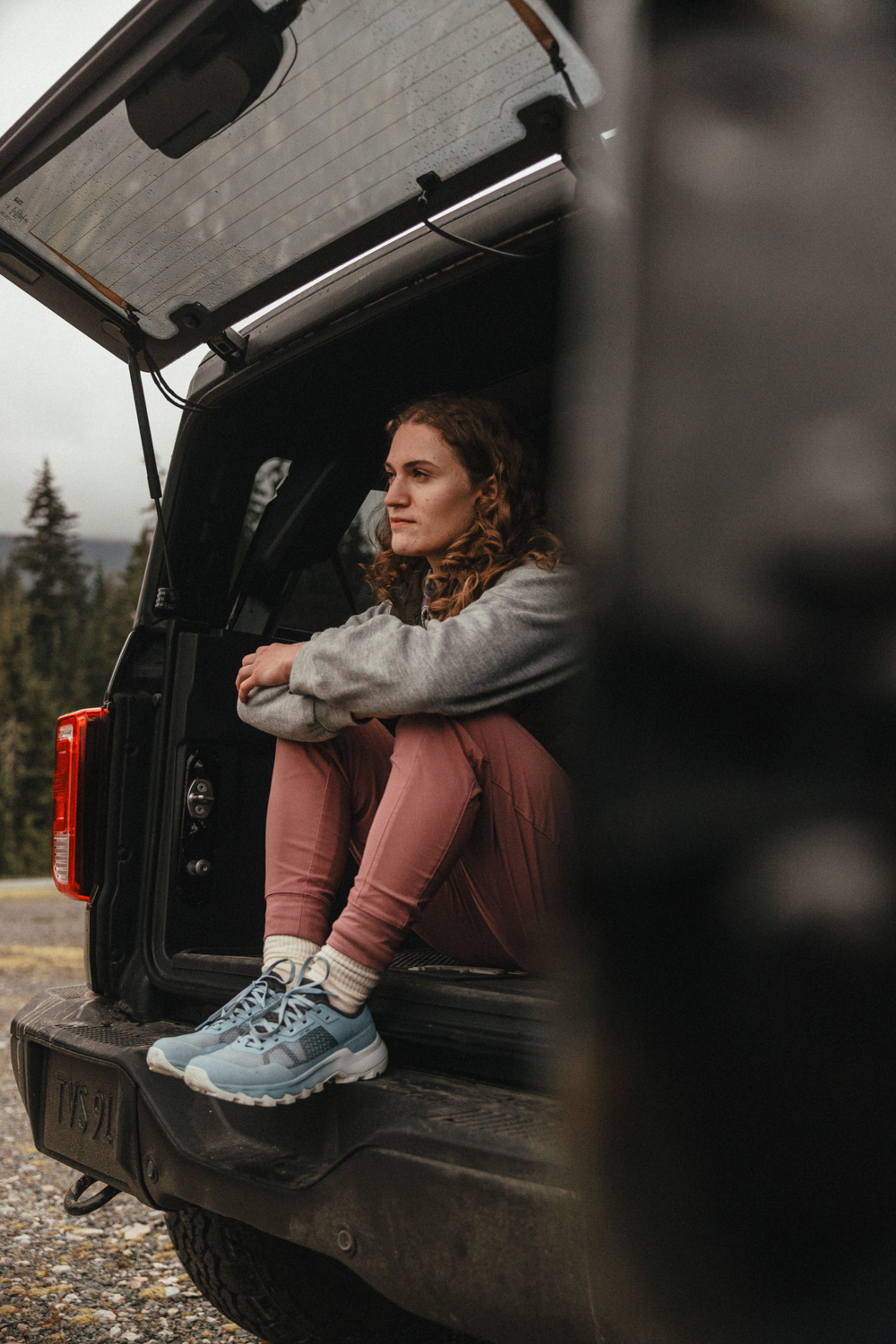 girl sitting back of bronco