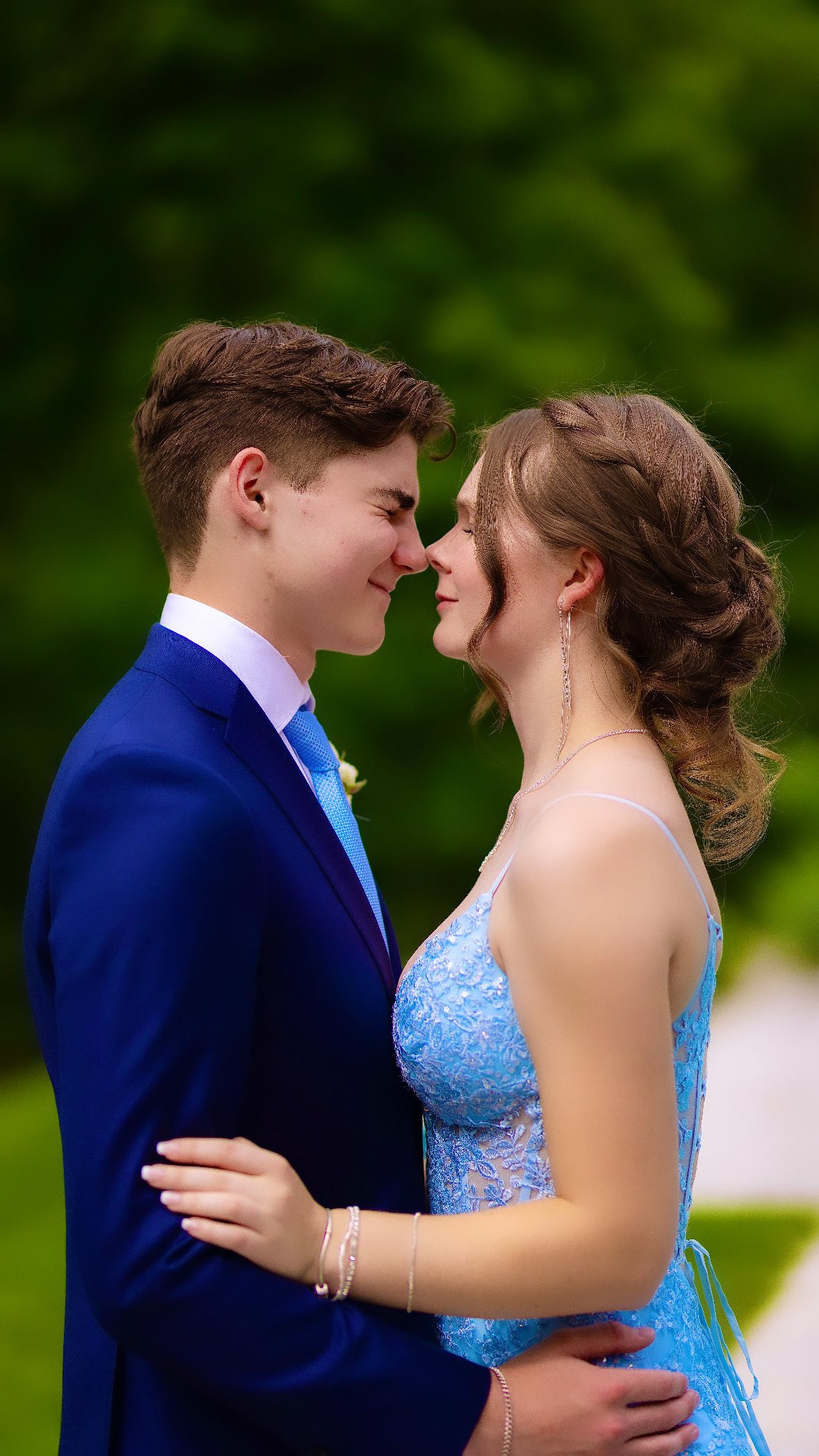 Couple forehead to forehead in the garden, eyes closed