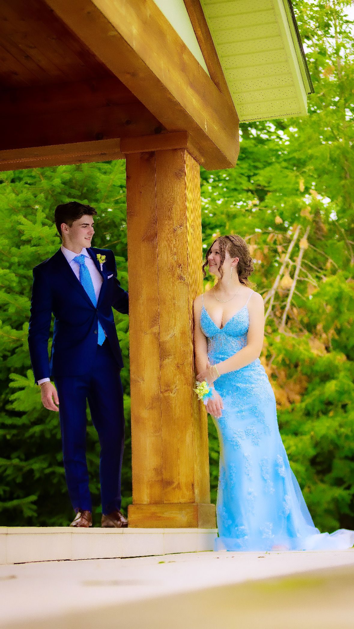 Couple in formal wear beneath a timber gazebo
