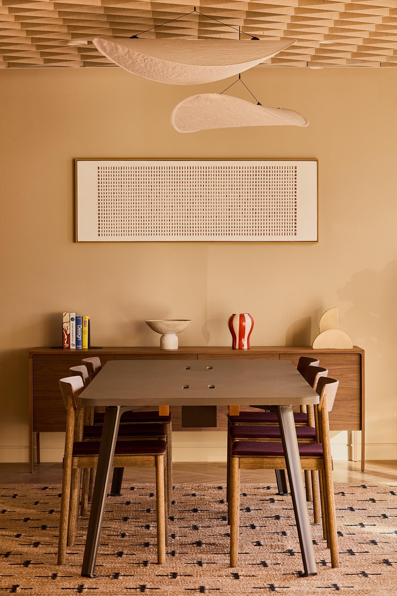 A dining table in a modern yet retro carpeted room