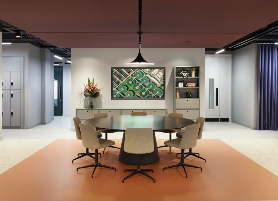 An office space with chairs around a round table