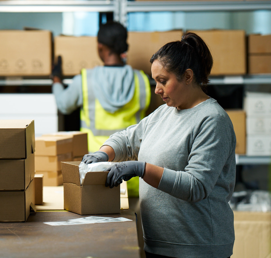 women packaging in warehouse