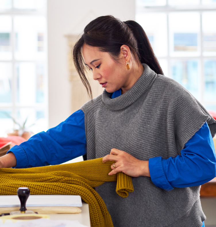 women folding sweater