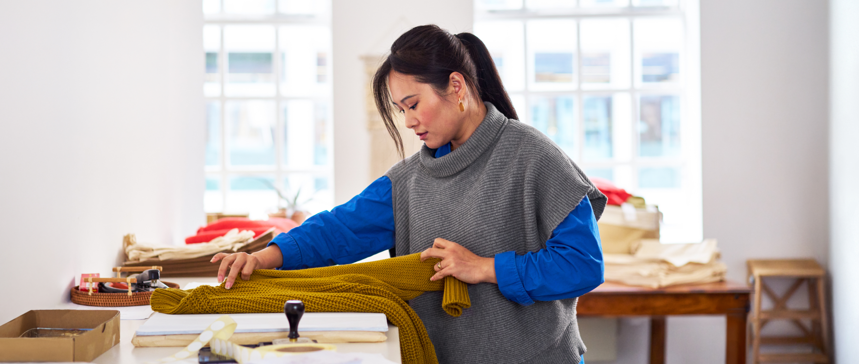 women folding sweater