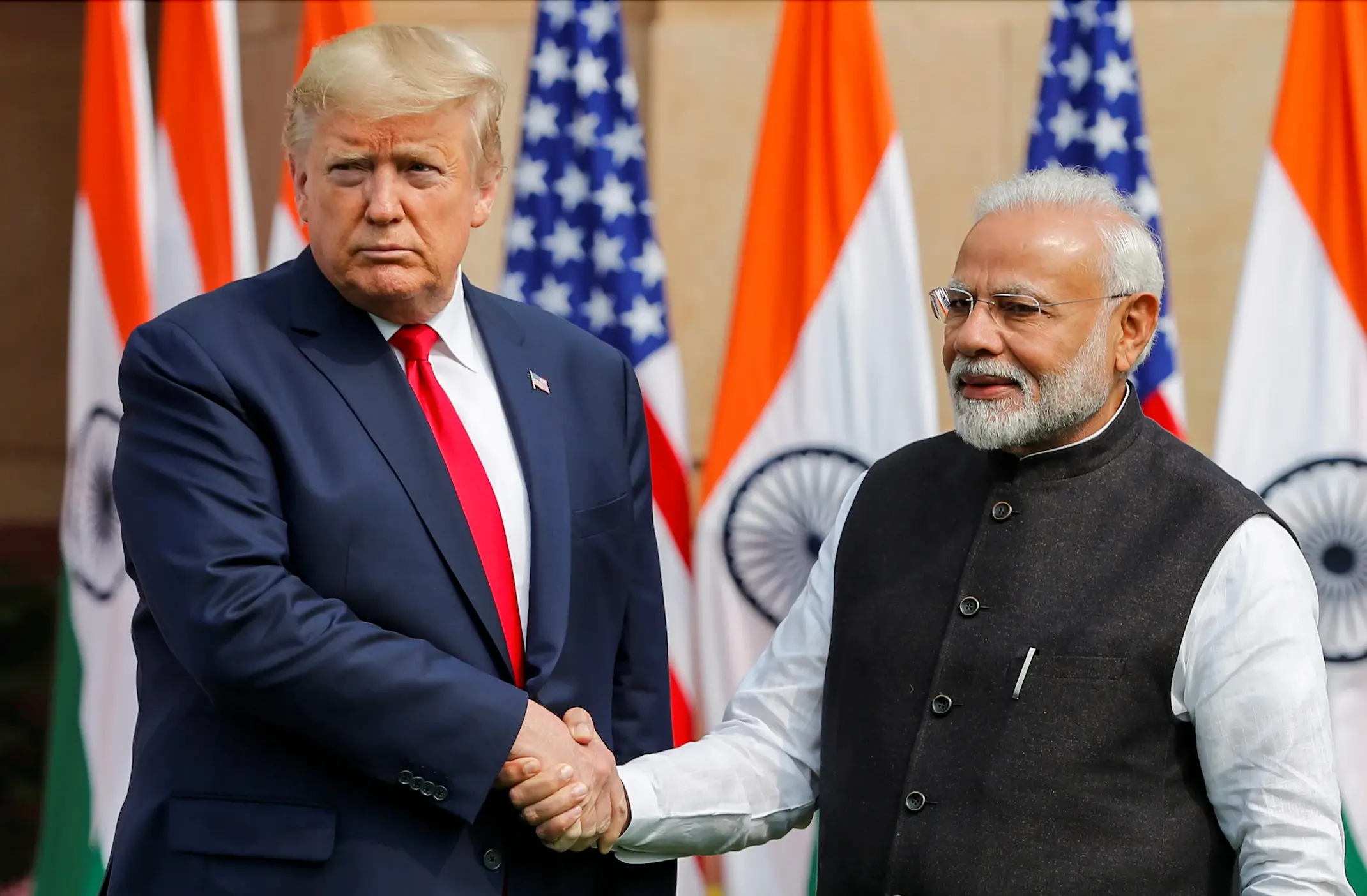 Donald Trump and Narendra Modi shaking hands.