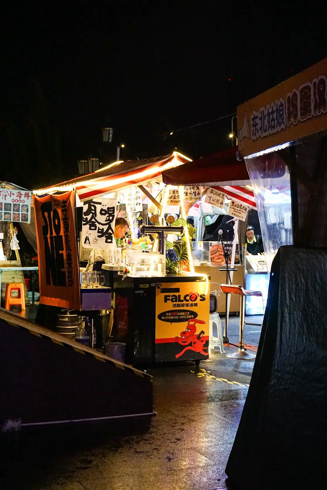 A booth in the Luheng night market at night