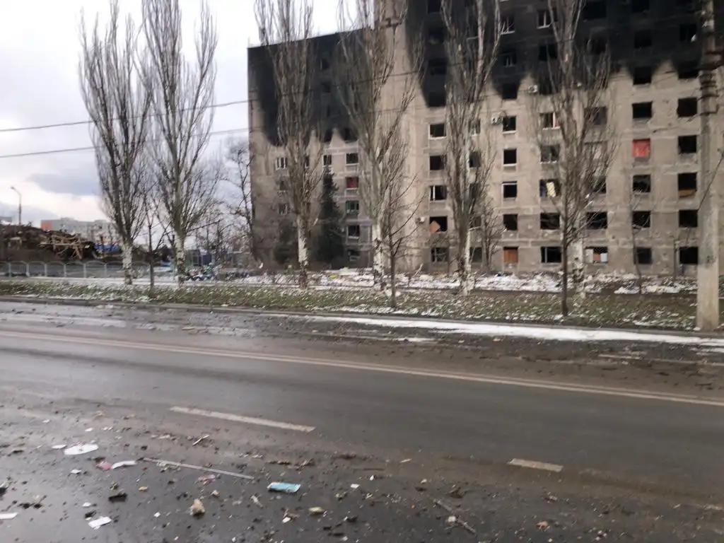 Rainy street with buildings in ruin