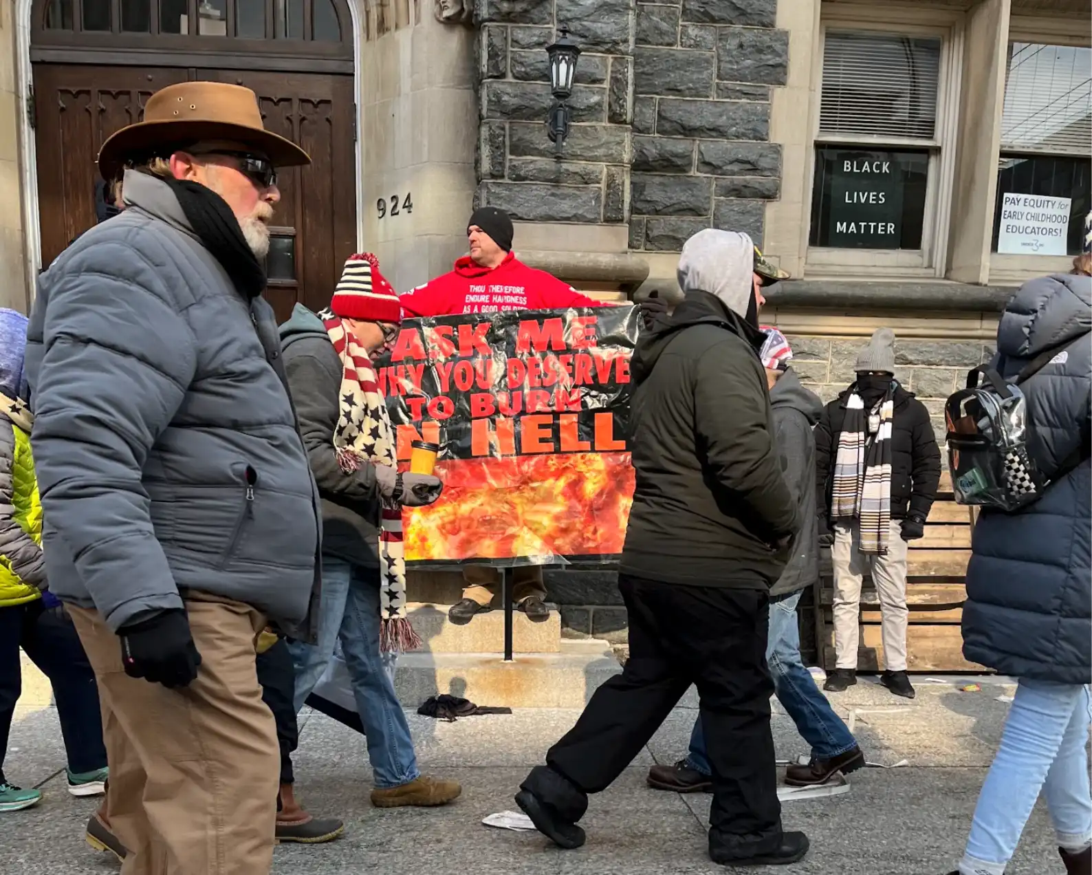Man standing with a political poster.