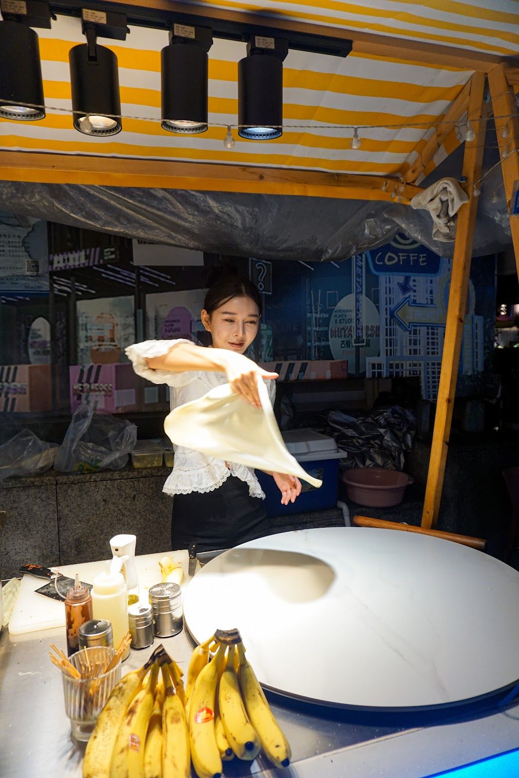 Lady spinning crepes