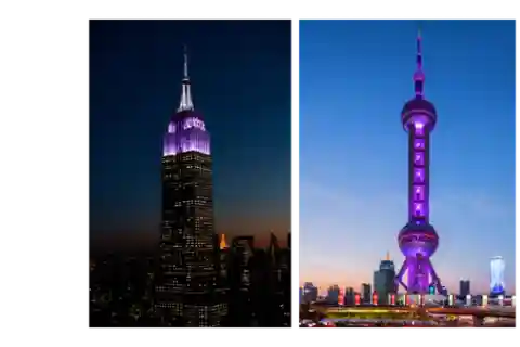 The Empire State building beside the Pearl Tower, both lit up in violet.