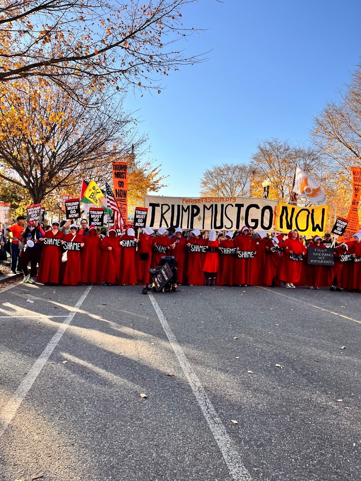 People in red carrying flags