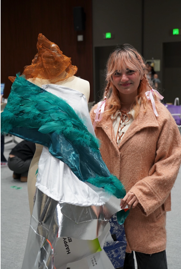 Woman posing with the costume she made.