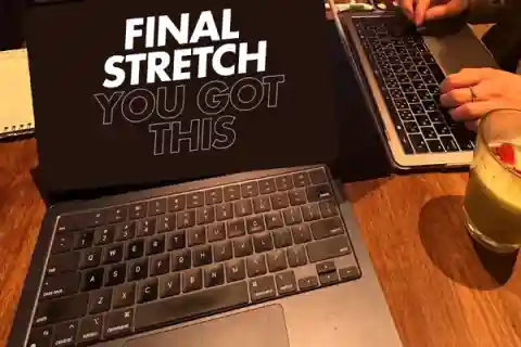 Picture of a computer displaying the words "Final Stretch You Got This" on a table in a cafe