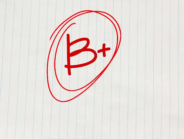 A paper with a B+ circled in red ink