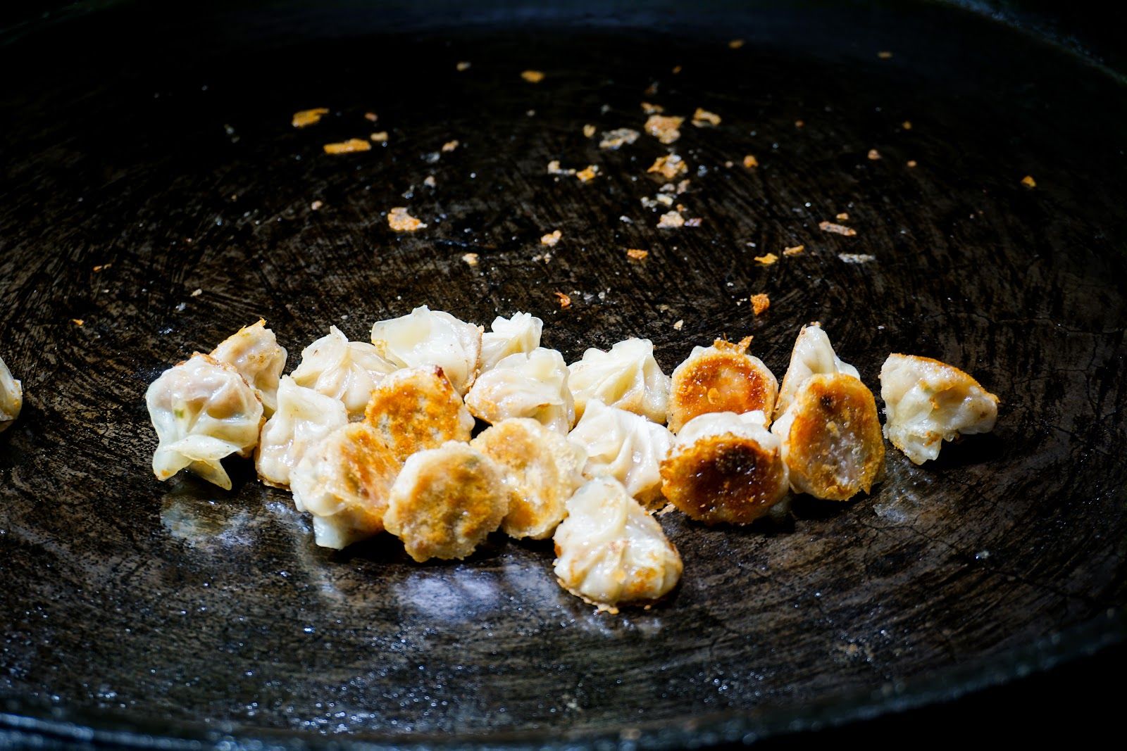 Pan-fried dumplings in a wok