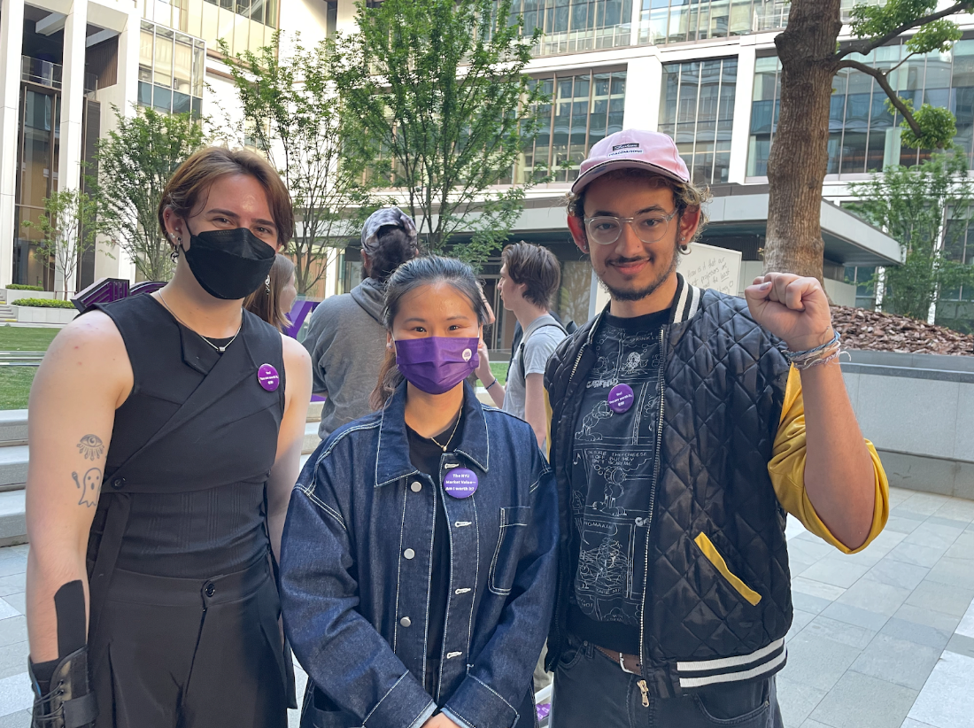 Students and a Chinese Language Lecturer standing wearing buttons