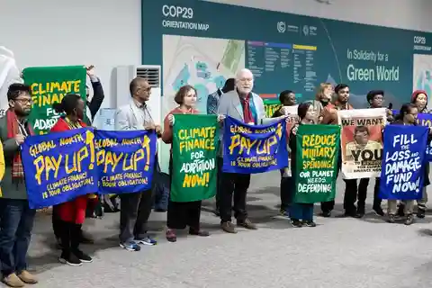 Climate protesters standing with manners at Conference of the Parities (COP) 29