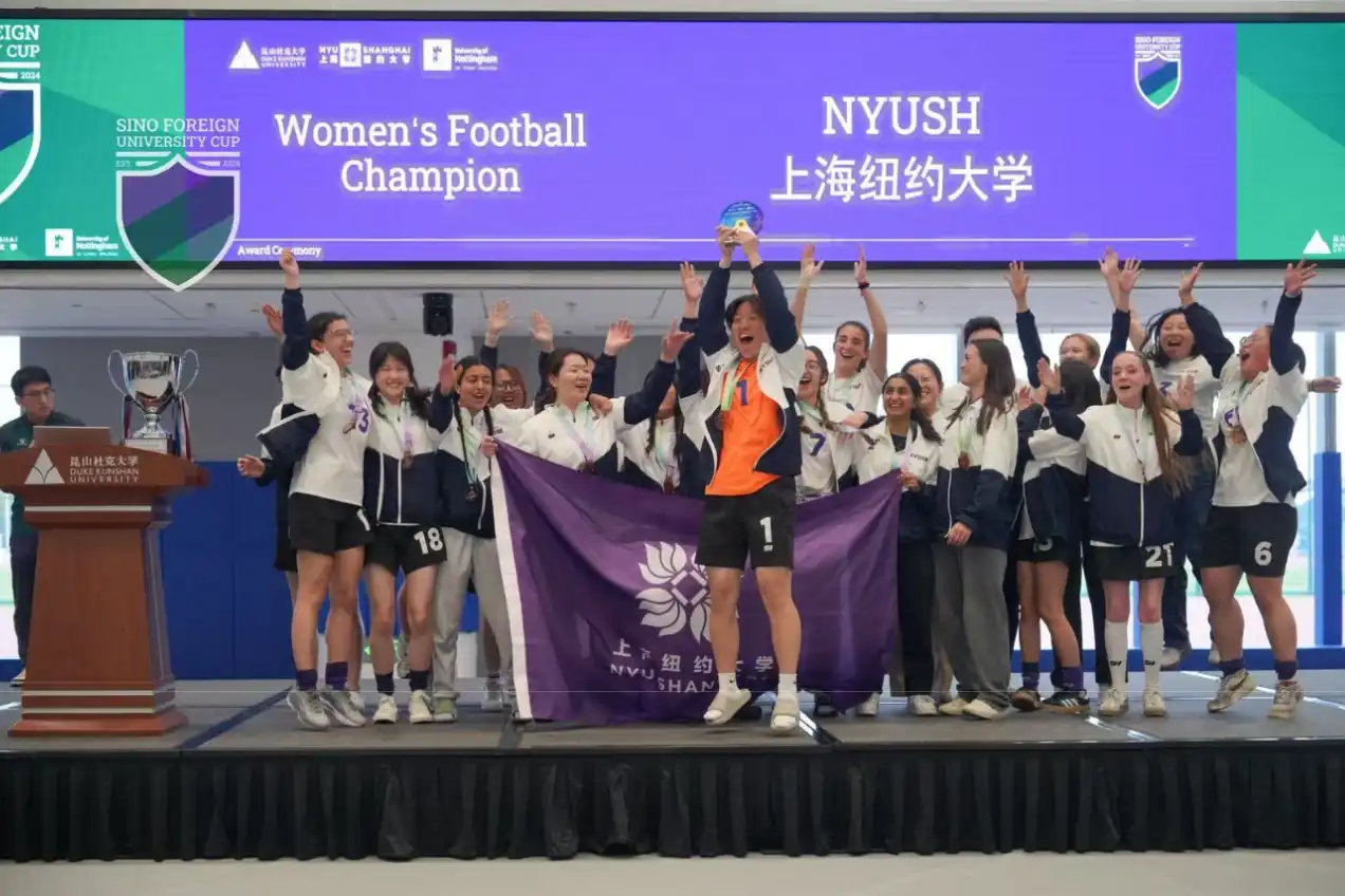 NYU Shanghai's women football champions stand on stage