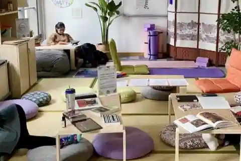 Cushions and tables around the room with students studying.