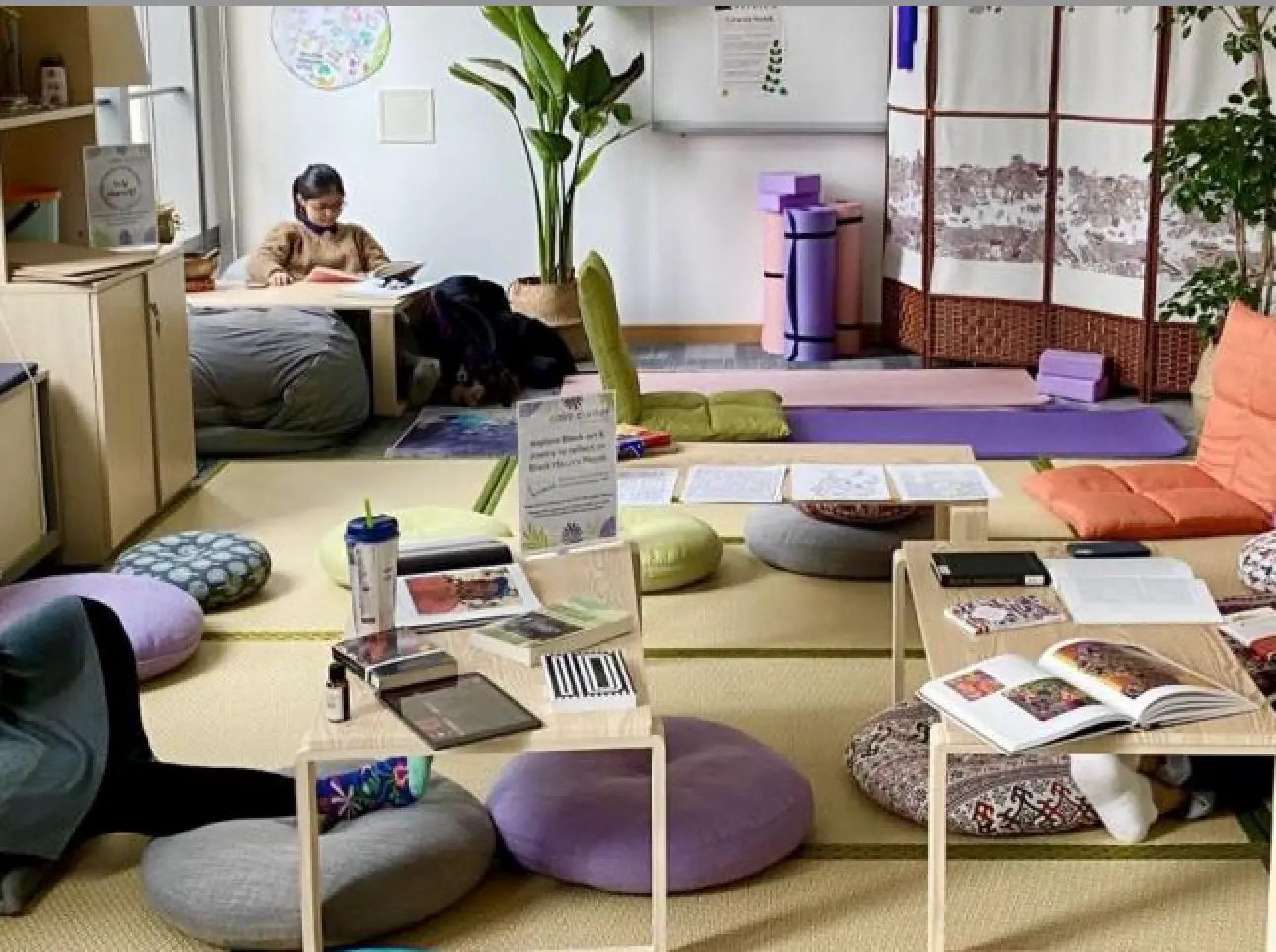 Cushions and tables around the room with students studying.