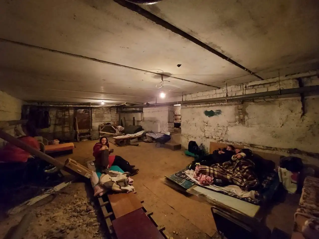 People sitting in a dimly lit basement