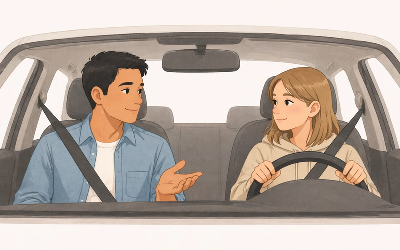 Parent teaching teenage daughter to drive while sitting together in a parked car before a driving lesson.