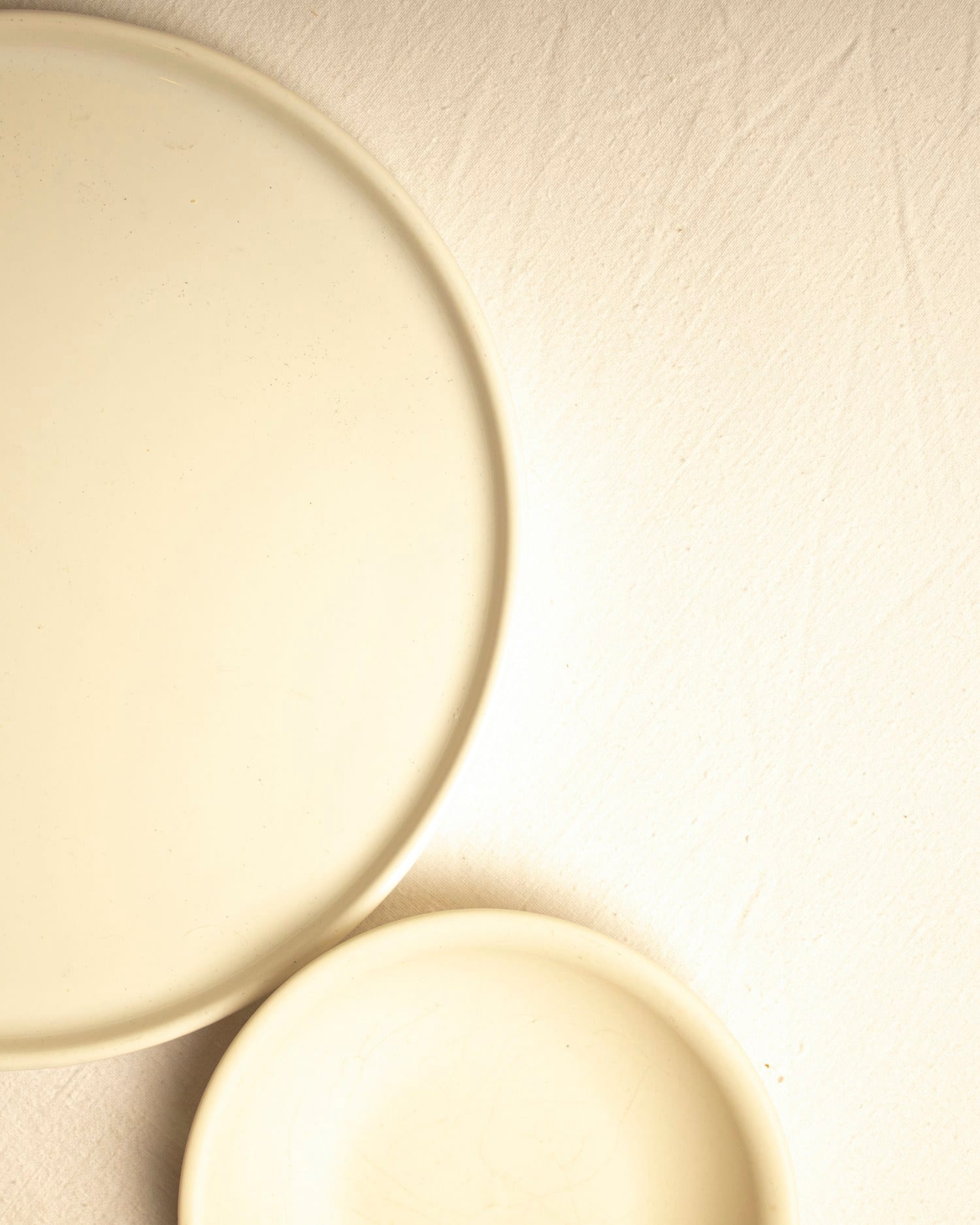 Two overlapping porcelain plates in soft directional light