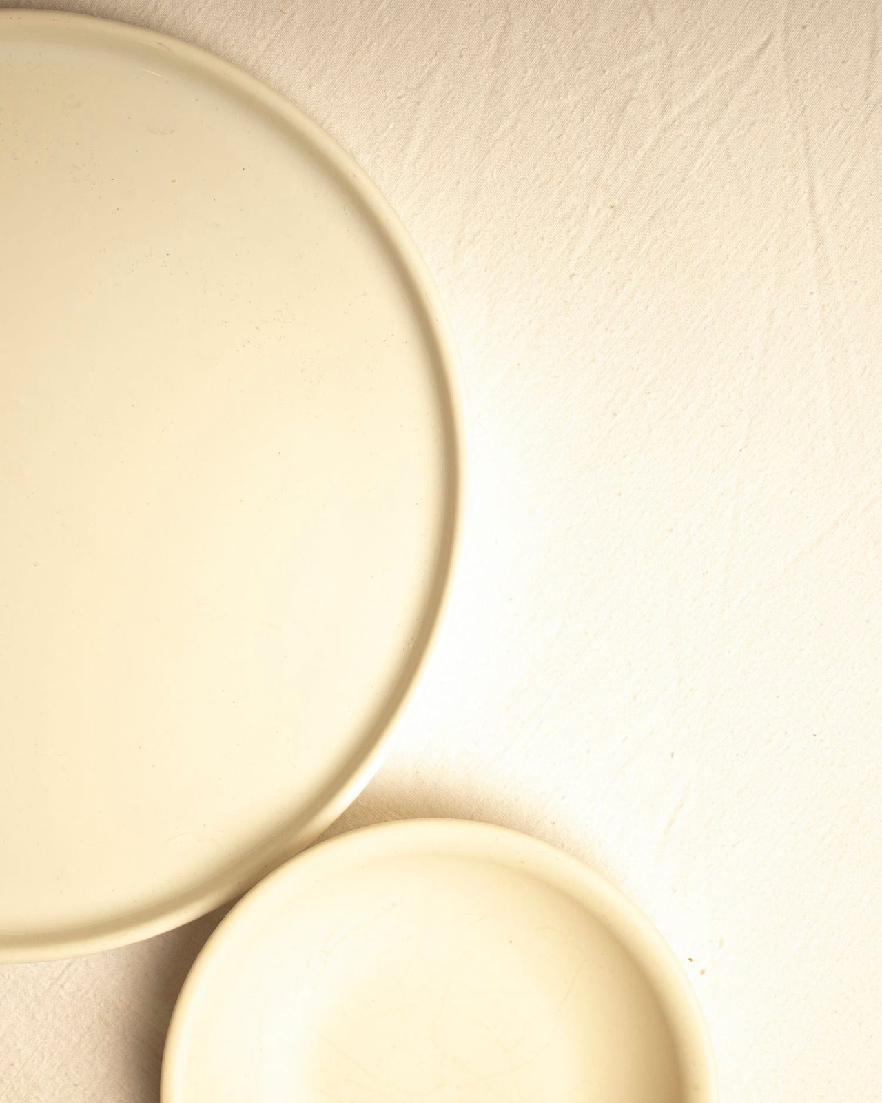 Two overlapping porcelain plates in soft directional light