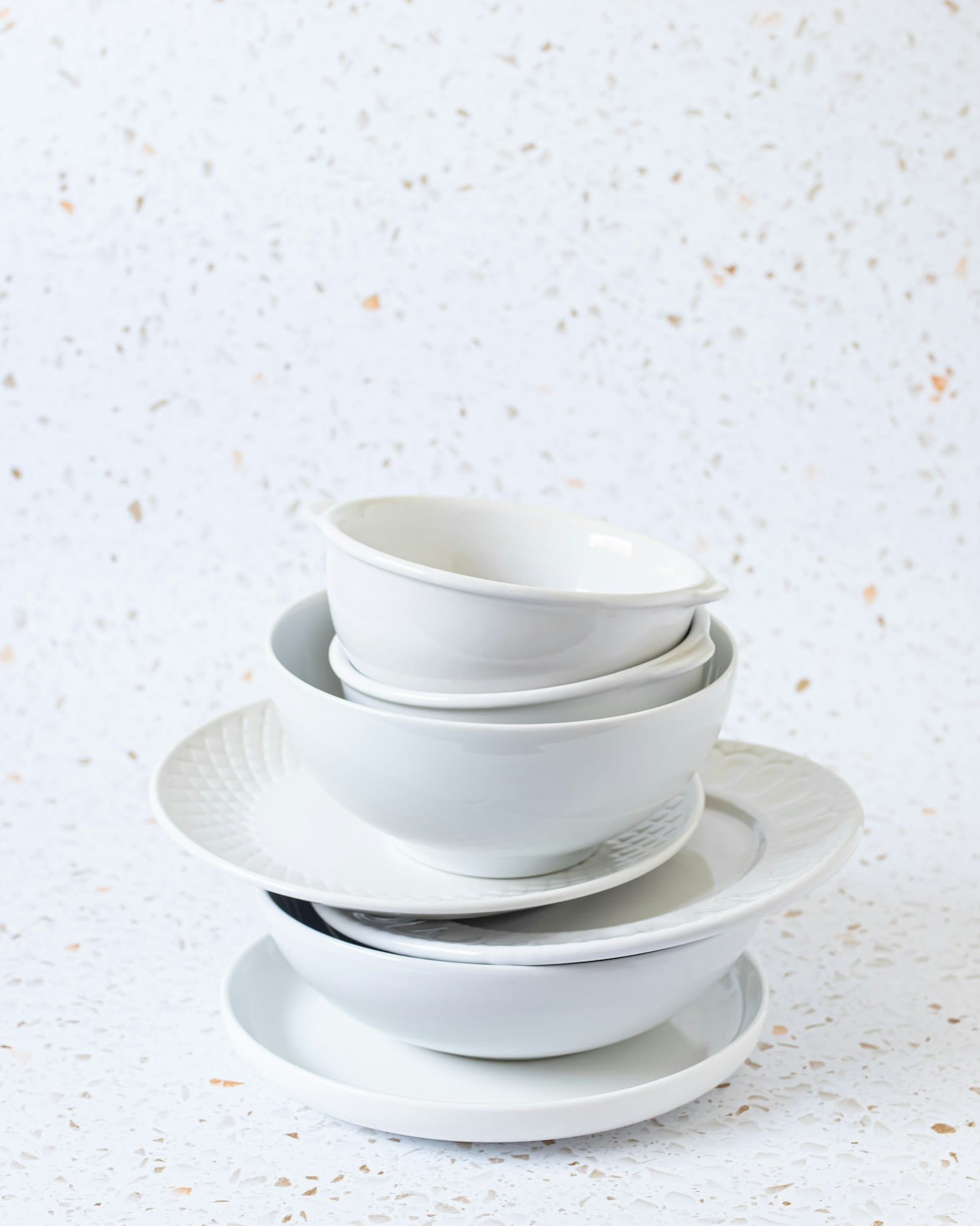 Four porcelain bowls nested into a neat stack