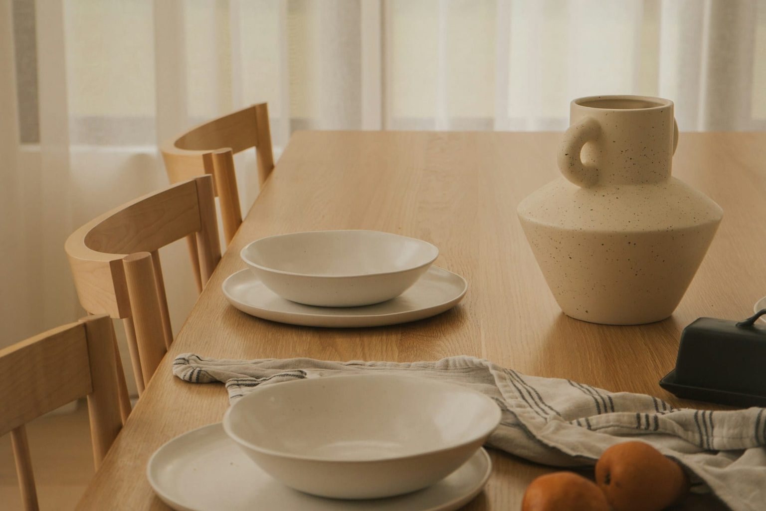 A neutral table setting photographed in soft daylight