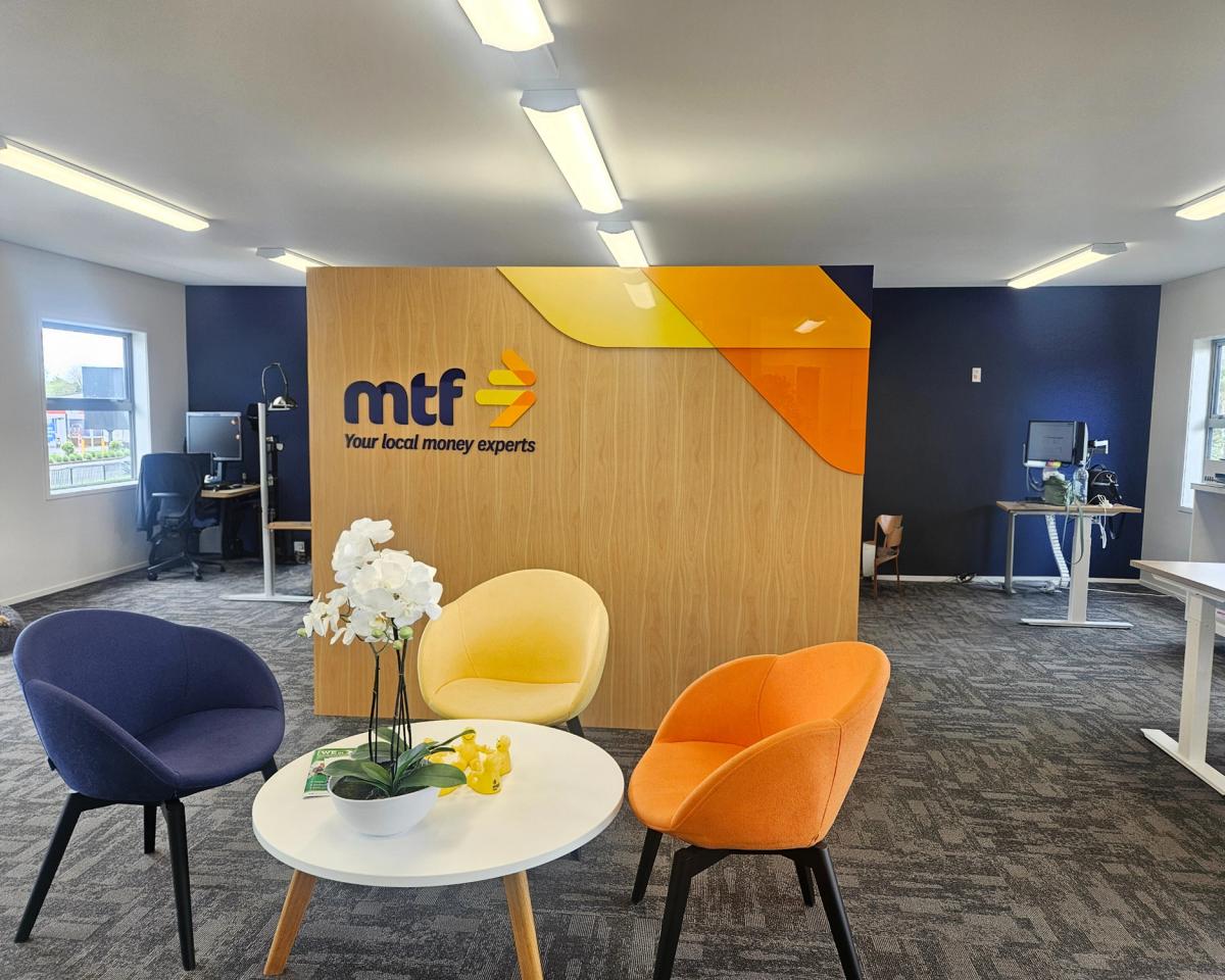 MTF Kumeu reception interior with 3D acrylic logo on a wood-veneer feature wall