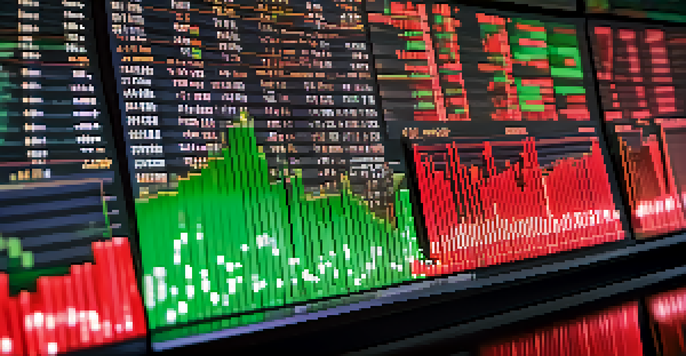 A close-up of a candlestick chart with green and red candles on a computer screen, set against a blurred modern trading desk.