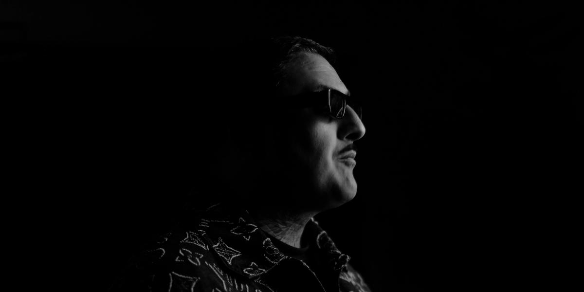 Black and white side-profile press shot of Acid Harry